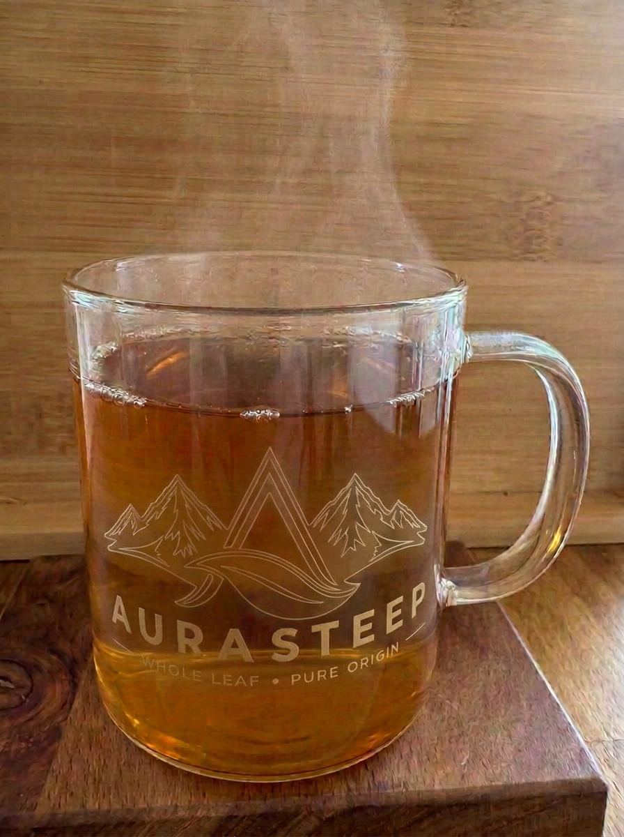 A clear glass Aurasteep® cup filled with amber oolong tea, steam rising gently.